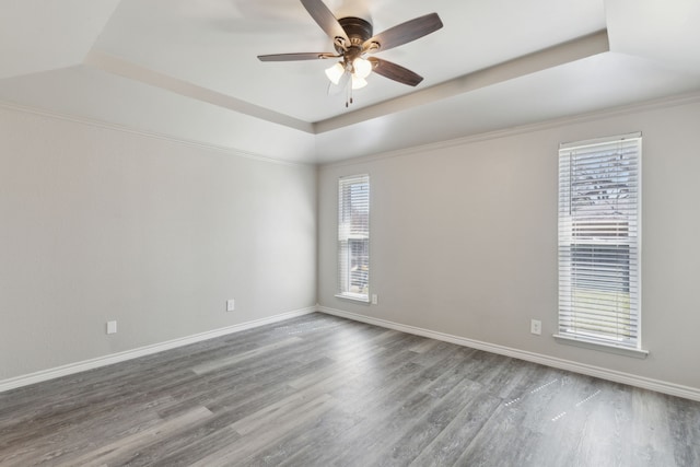 4018 Tobin Trl, Rowlett, TX 75088 - spare room featuring wood finished floors, a ceiling fan, baseboards, and a raised ceiling