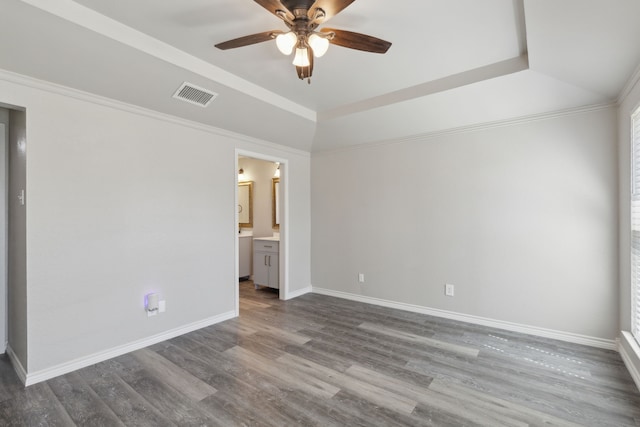 4018 Tobin Trl, Rowlett, TX 75088 - unfurnished bedroom with dark wood-style floors, baseboards, ensuite bath, and a ceiling fan