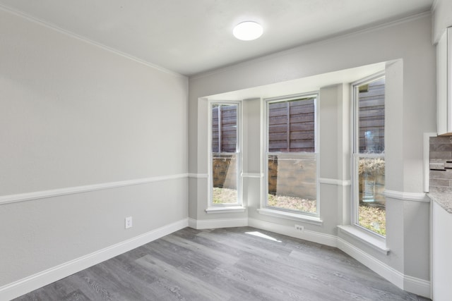 4018 Tobin Trl, Rowlett, TX 75088 - unfurnished room with wood finished floors, ornamental molding, and baseboards