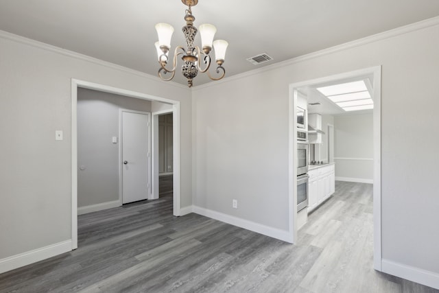 4018 Tobin Trl, Rowlett, TX 75088 - spare room featuring wood finished floors, a chandelier, baseboards, and ornamental molding