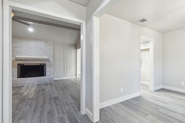 4018 Tobin Trl, Rowlett, TX 75088 - unfurnished living room featuring wood finished floors, baseboards, crown molding, and a brick fireplace