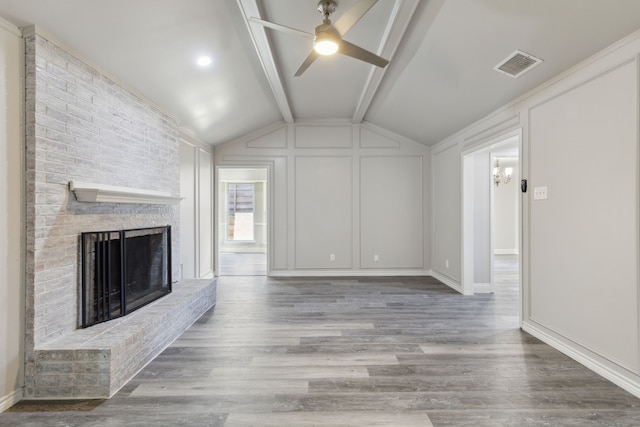 4018 Tobin Trl, Rowlett, TX 75088 - unfurnished living room with a brick fireplace, a ceiling fan, wood finished floors, and a decorative wall