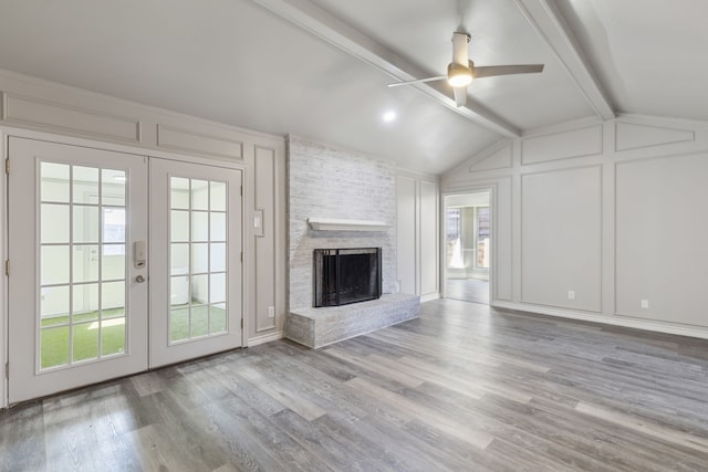4018 Tobin Trl, Rowlett, TX 75088 - unfurnished living room with a decorative wall, french doors, healthy amount of natural light, wood finished floors, and ceiling fan