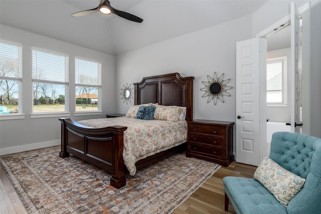 2652 Kessler Dr, Celina, TX 75009 - bedroom featuring lofted ceiling, multiple windows, wood finished floors, and baseboards