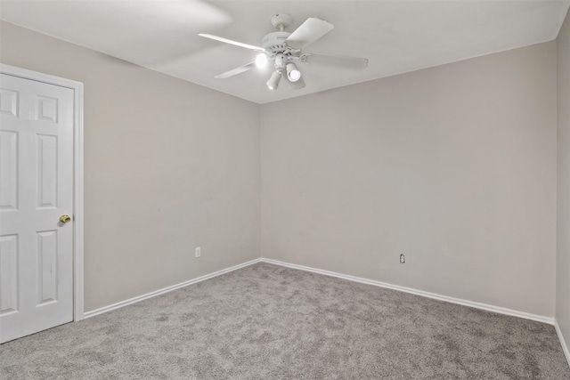 spare room featuring carpet flooring, baseboards, and ceiling fan