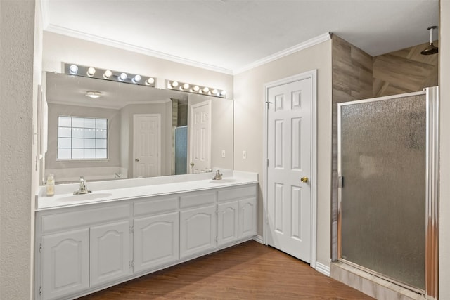 full bath with crown molding, a sink, double vanity, and a stall shower