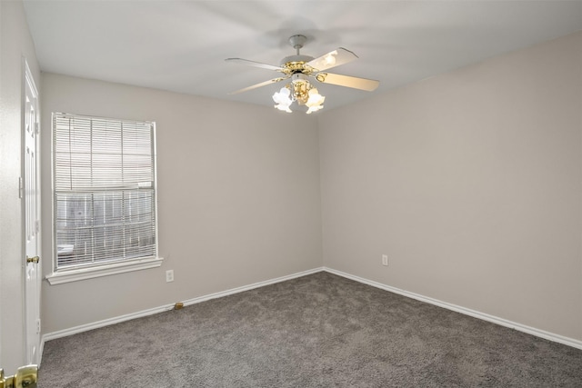 carpeted empty room with a ceiling fan and baseboards