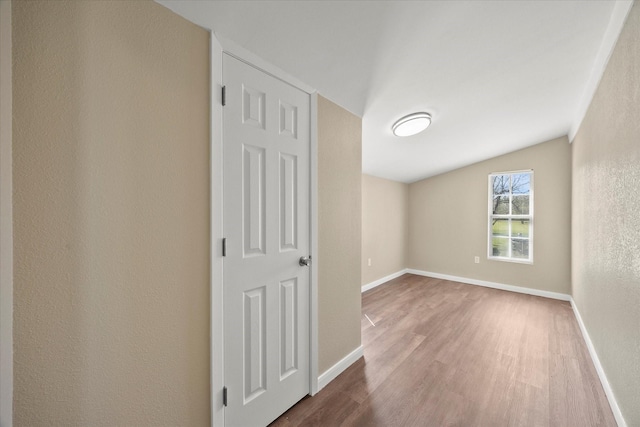 399 E College St, Alba, TX 75410 - empty room with baseboards, vaulted ceiling, wood finished floors, and a textured wall