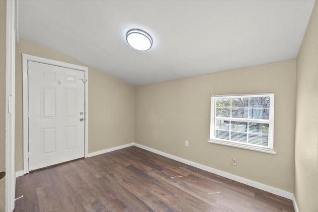 399 E College St, Alba, TX 75410 - empty room featuring baseboards, vaulted ceiling, and dark wood finished floors