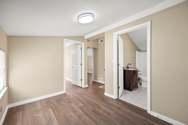 399 E College St, Alba, TX 75410 - interior space featuring dark wood finished floors, a sink, baseboards, and visible vents