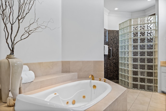 bathroom featuring tile patterned floors, walk in shower, ornamental molding, and a jetted tub