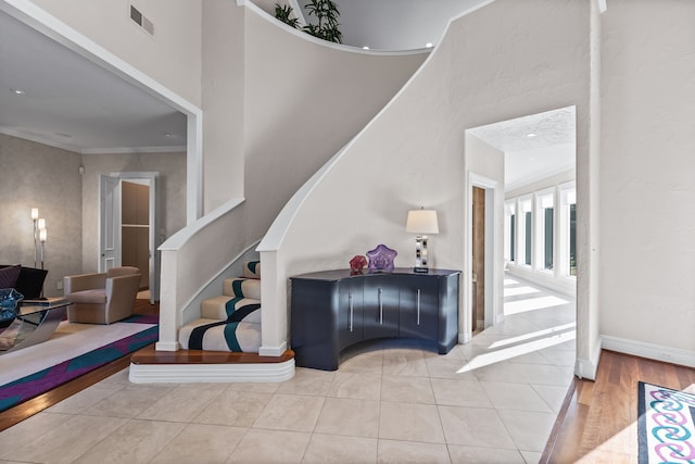 5819 Coolwater Cv, Dallas, TX 75252 - staircase with baseboards, a towering ceiling, ornamental molding, and wood finished floors