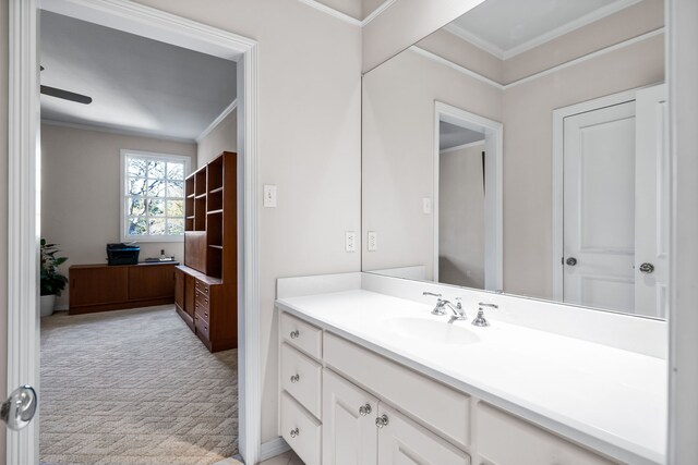 carpeted living room featuring ceiling fan, ornamental molding, and baseboards