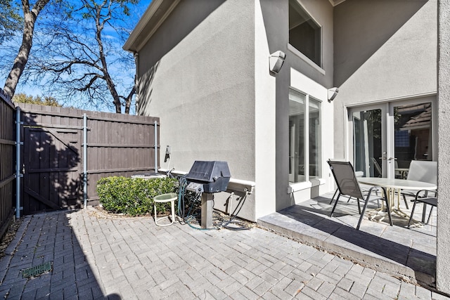 view of front of home featuring driveway, a tile roof, and stucco siding