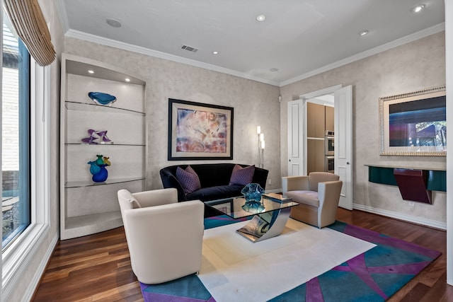 dining room with a tiled fireplace, crown molding, a high ceiling, and visible vents