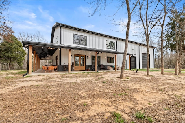 exterior space featuring french doors, a garage, board and batten siding, and a patio area