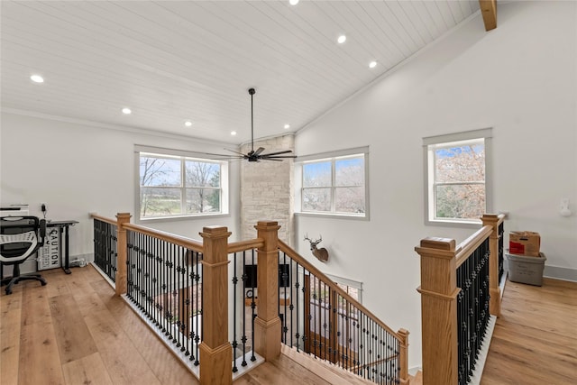 stairs featuring plenty of natural light, wood finished floors, and wooden ceiling