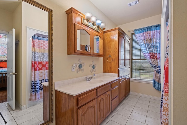 bathroom with tile patterned floors, visible vents, baseboards, and vanity