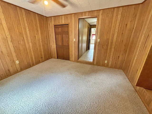 2431 N Jefferson, Mount Pleasant, TX 75455 - carpeted empty room featuring wooden walls and ceiling fan
