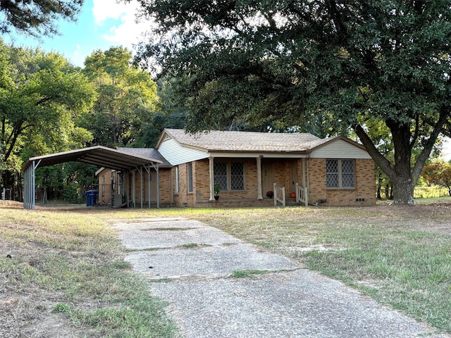 2431 N Jefferson, Mount Pleasant, TX 75455 - ranch-style house with asphalt driveway, a carport, brick siding, and a front yard