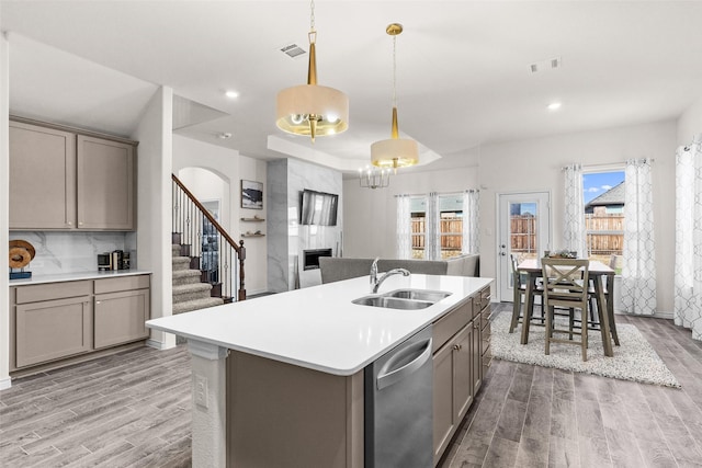 kitchen with a sink, dishwasher, visible vents, and gray cabinetry