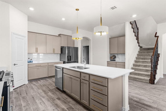 kitchen featuring a sink, gray cabinets, and stainless steel appliances