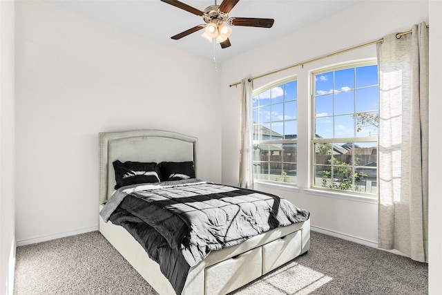 carpeted bedroom featuring ceiling fan and baseboards