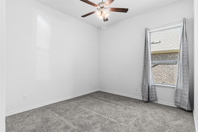 unfurnished room with a wealth of natural light, baseboards, a ceiling fan, and carpet floors