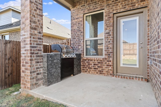 view of patio / terrace featuring grilling area and fence