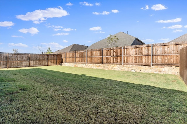 view of yard with a fenced backyard