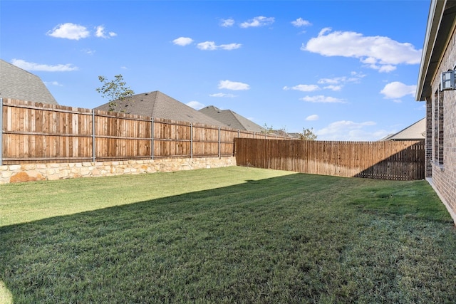 view of yard with a fenced backyard