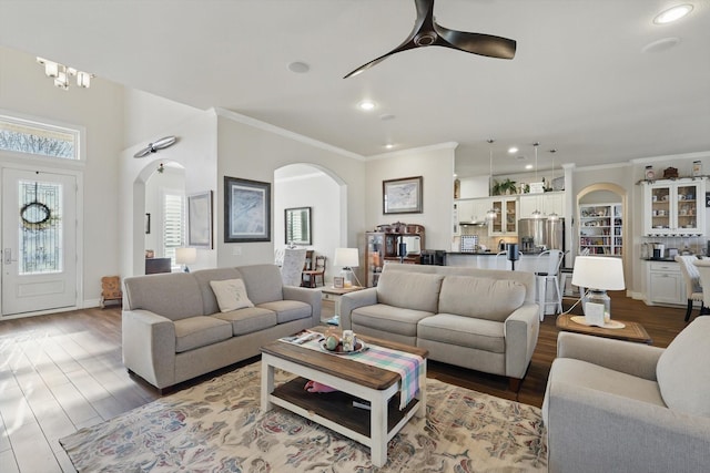 12265 Indian Creek Dr, Fort Worth, TX 76179 - living room featuring recessed lighting, ceiling fan, dark wood-type flooring, ornamental molding, and arched walkways