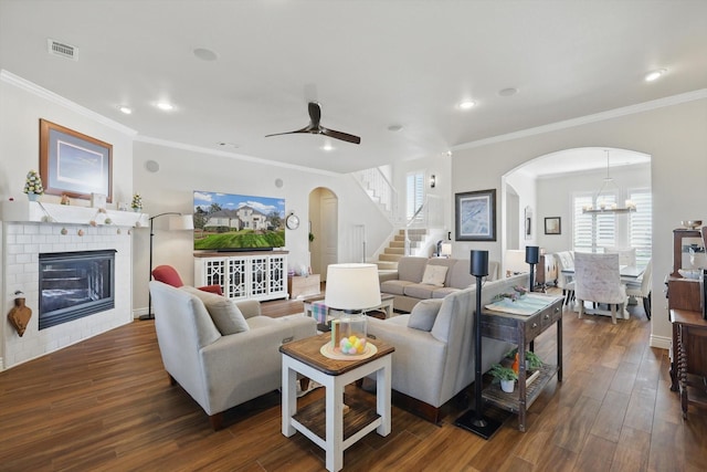 12265 Indian Creek Dr, Fort Worth, TX 76179 - living area with crown molding, arched walkways, stairs, and a fireplace