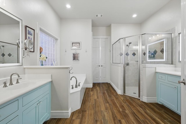 12265 Indian Creek Dr, Fort Worth, TX 76179 - bathroom featuring vanity, a bath, a stall shower, visible vents, and wood finished floors