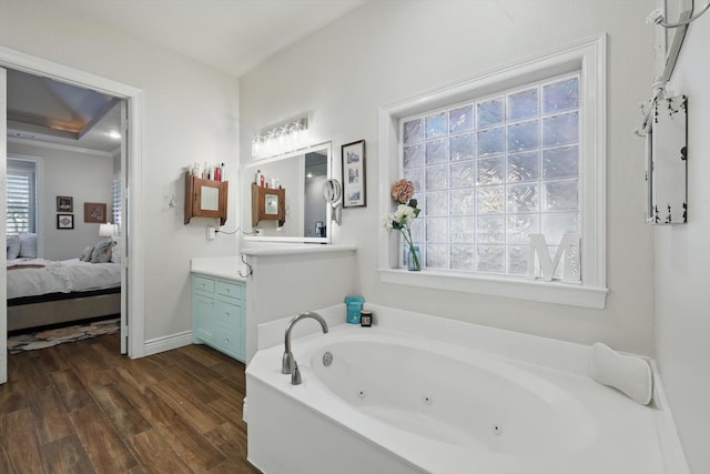12265 Indian Creek Dr, Fort Worth, TX 76179 - ensuite bathroom with a tub with jets, wood finished floors, ensuite bathroom, vanity, and baseboards