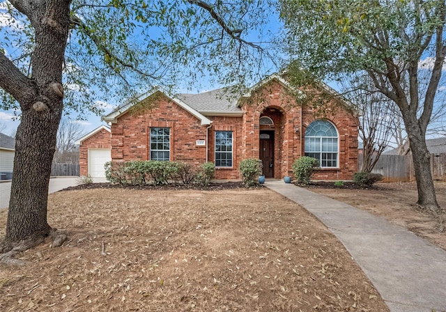 single story home featuring brick siding, a garage, fence, and roof with shingles
