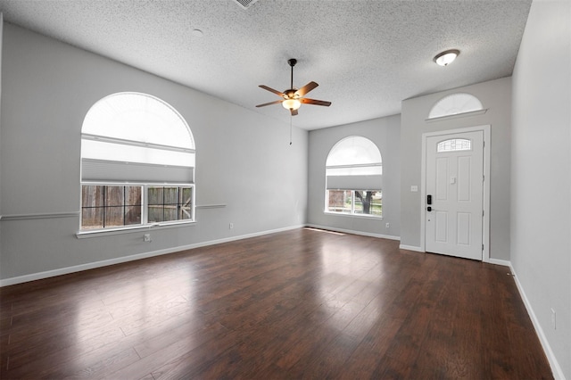 entryway featuring baseboards, a textured ceiling, ceiling fan, and wood finished floors