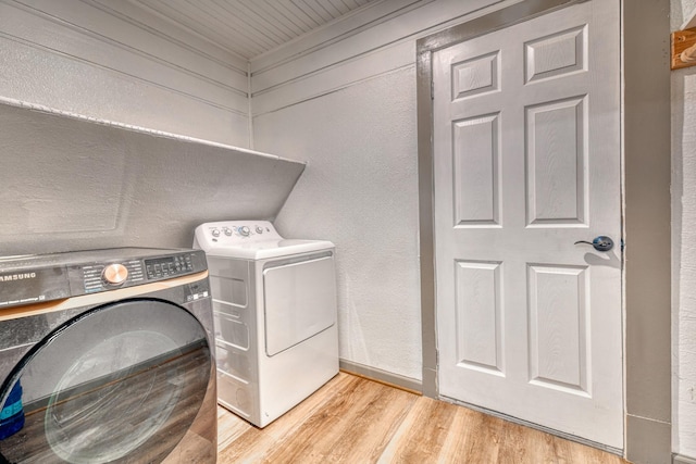 laundry room featuring washer and clothes dryer, laundry area, and light wood finished floors