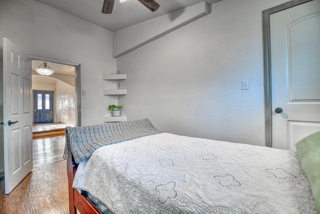 bedroom with a ceiling fan and wood finished floors