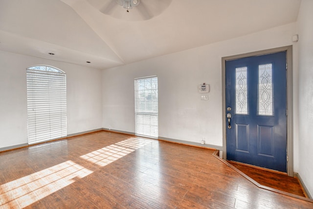entrance foyer featuring hardwood / wood-style floors, vaulted ceiling, a ceiling fan, and baseboards