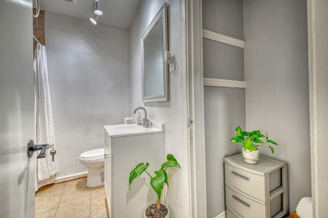 bathroom featuring tile patterned floors, toilet, and vanity