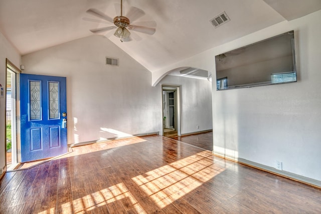 foyer entrance featuring a ceiling fan, arched walkways, visible vents, and hardwood / wood-style floors