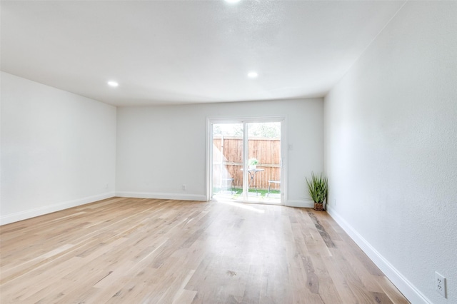 spare room featuring baseboards, recessed lighting, and light wood-style flooring