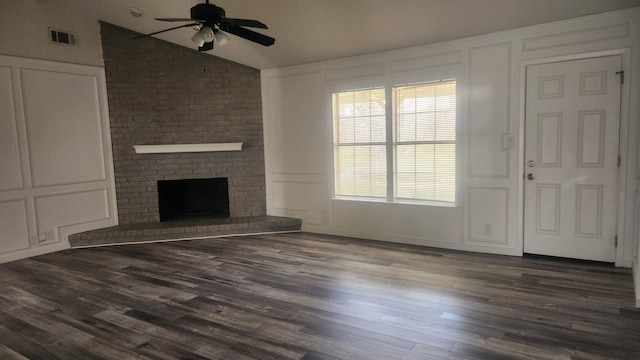 5919 Pleasant Hill Dr, Arlington, TX 76016 - unfurnished living room with a decorative wall, ceiling fan, lofted ceiling, dark wood-style floors, and a brick fireplace