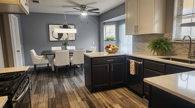 5919 Pleasant Hill Dr, Arlington, TX 76016 - kitchen featuring a sink, dishwashing machine, dark wood finished floors, and light countertops