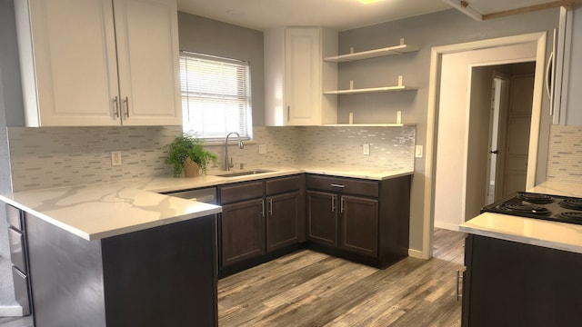 5919 Pleasant Hill Dr, Arlington, TX 76016 - kitchen with a sink, wood finished floors, white cabinetry, and tasteful backsplash