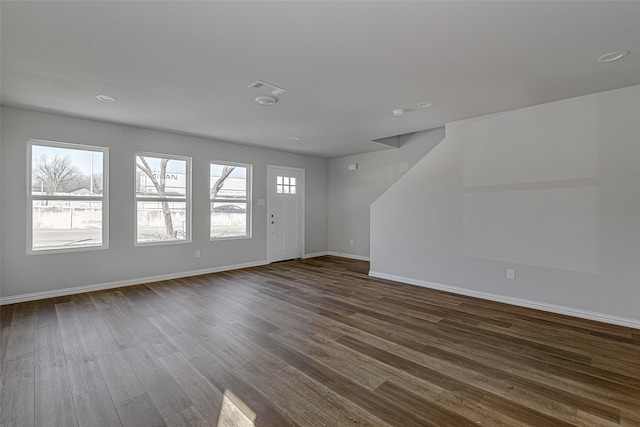 1405 S Freeway Freeway, Fort Worth, TX 76104 - unfurnished living room with dark wood-type flooring, visible vents, recessed lighting, and baseboards