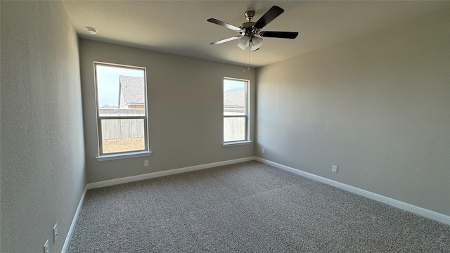 carpeted empty room with baseboards and ceiling fan