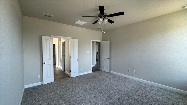 unfurnished bedroom featuring visible vents, ceiling fan, baseboards, and carpet