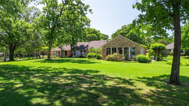 39 Lakeside Dr, Star Harbor, TX 75148 - rear view of house featuring brick siding and a lawn